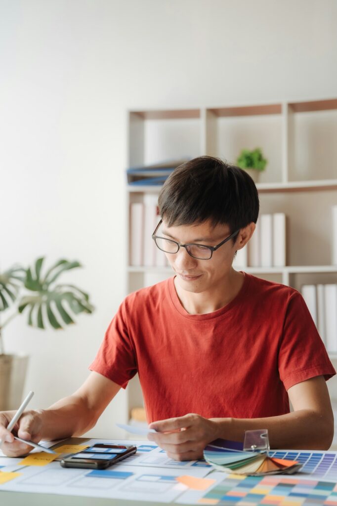 Creative male web designer planning application